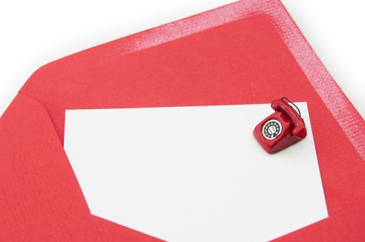 Blank business card inside an open envelope with a small phone on one side 