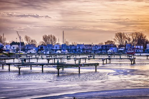 Sunset behind floating homes at Bluffers park marina in Toronto, Canada.  Winter.