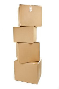 Stack of four large cardboard moving boxes isolated on white