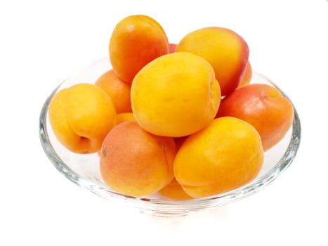 Whole apricot in a glass bowl isolated towards white