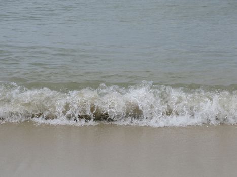 Wave on sandy beach, Mallorca, Balearic islands, Spain.