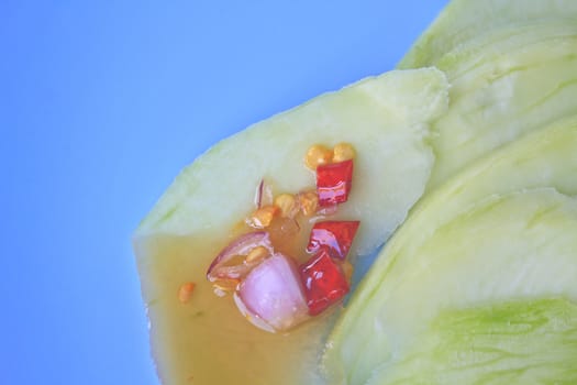 mangoes with sauce, mangoes dipped into a sweet fishy paste with dried shrimp and red onions in plate