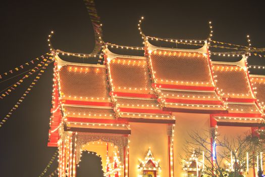 Pagodas and churches at the night in the temple fair,Thailand