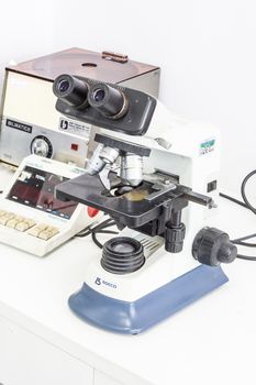 microscope and blood counter in real laboratory setting,white scene