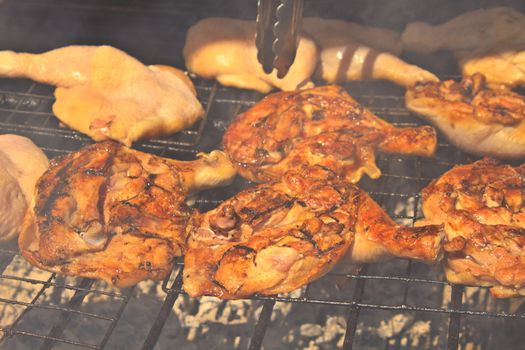 Grilled chicken thigh on the flaming grill