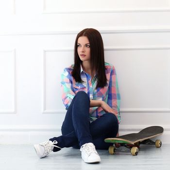 Cute, attractive teenager with skateboard