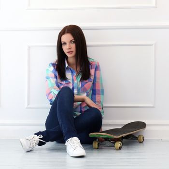 Cute, attractive teenager with skateboard