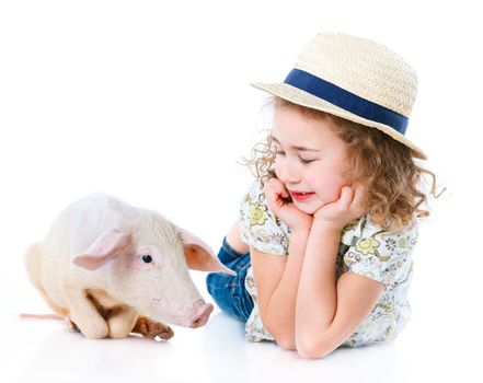 Little farmer. Cute girl with pig. Isolated on white background.