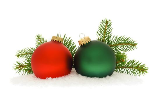 Red and green christmas balls with spruce tree branch isolated on white background