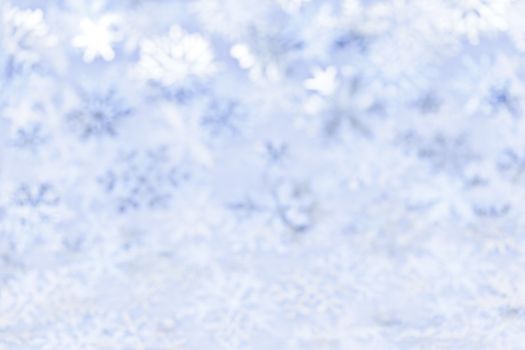 Blue abstract blurred Christmas background with snowflakes