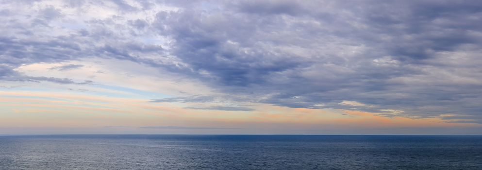 Panoramic view of dramatic sunset sky over vast ocean
