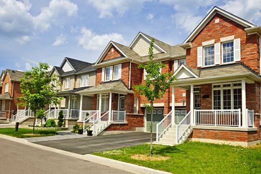 Suburban residential street with row of red brick houses