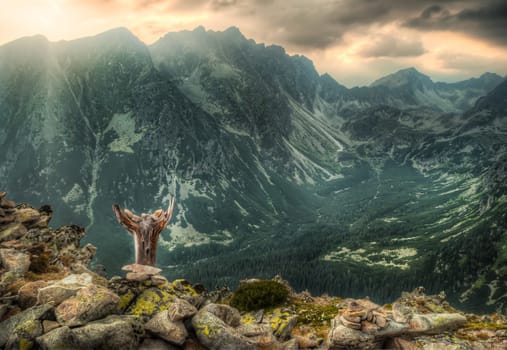 mountain landscape with rocks and totem in foreground and Koprovsky Peak in background, High Tatras, Slovakia