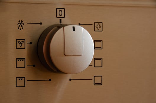 Silver on off button on the cooker and oven.