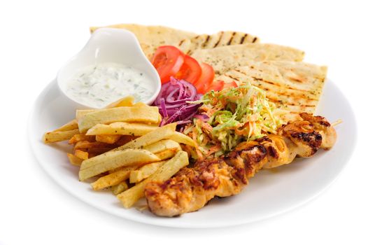 one portion of french fries, chicken kebab, salad and roasted pita