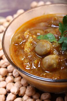 spicy chana masala, raw chickpeas around the bowl
indian dish