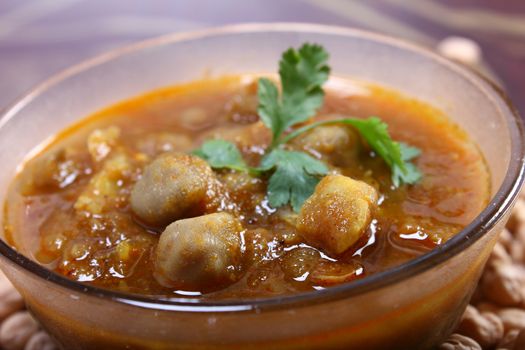 spicy chana masala, raw chickpeas around the bowl
indian dish