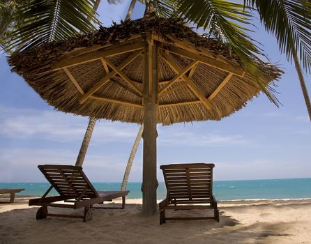 sun loungeres and  Umbrellas against  blue sea at sun day Mui Ne, Vietnam