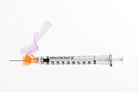 Medical single use safety syringe isolated on white background