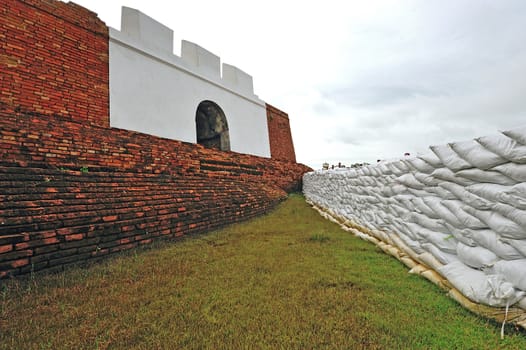 sandbags to protect ancient ruins in Ayuttaya, Thailand during the seasonal monsoon flooding.