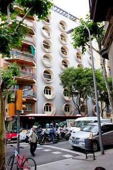 architecture in the streets of Barcelona, 13 June 2013: pedestrian crossing near the apartment house with round windows, Editorial use only