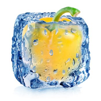 Yellow pepper in ice cube with drops isolated on white