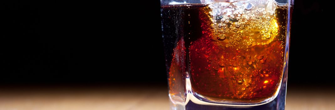 rum and cola in glass with ice