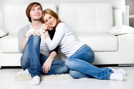 Happy couple relaxing in living room