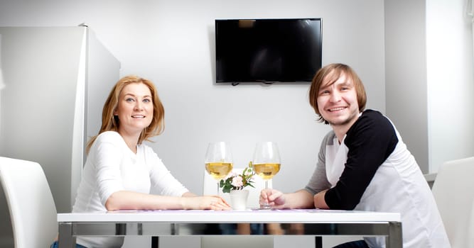 young woman in home having wine with her husband