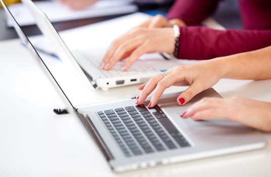 Female hands typing on a keyboard