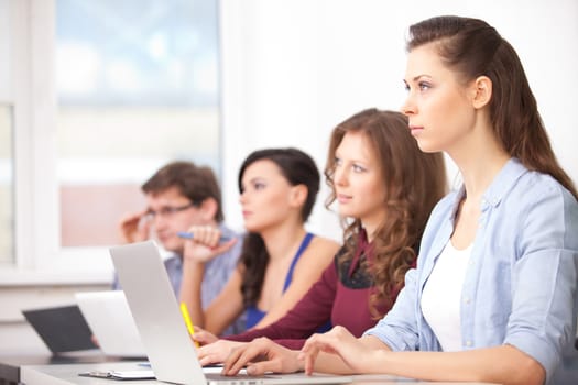 students with computers studying at school - education concept