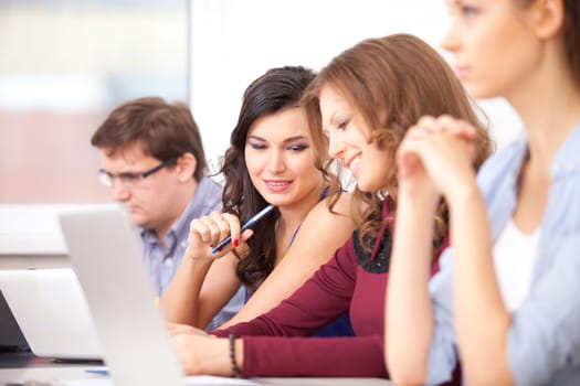 students with computers studying at school - education concept