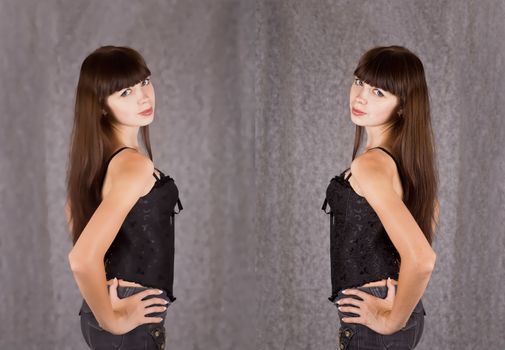 Portrait of a girl with long dark hair, dressed in black clothes on gray blurred background