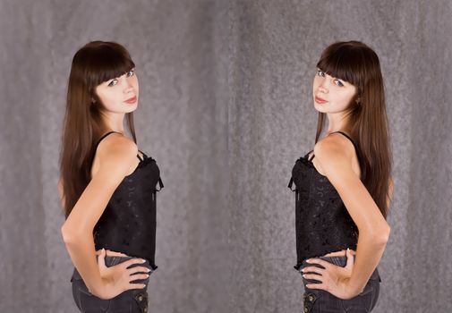 Portrait of a girl with long dark hair, dressed in black clothes on gray blurred background