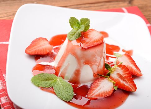 Italian dessert panna cotta with fresh strawberries