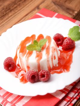 Italian dessert panna cotta with raspberries