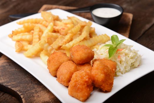 Fries with chicken nuggets and salad