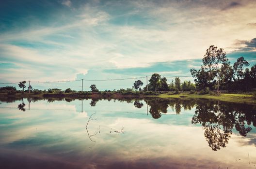 Pond and clouds in spring nature landscape in Thailand