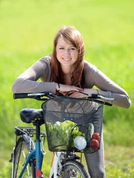 Beautiful young woman with bicycle
