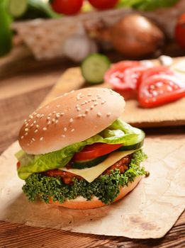 Homemade hamburgers with cheese, tomatoes and cucumbers