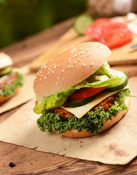 Homemade hamburgers with cheese, tomatoes and cucumbers