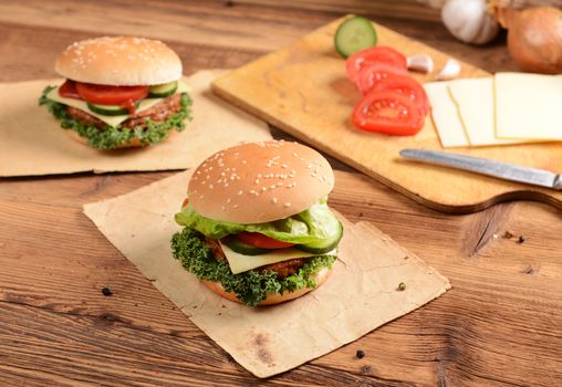 Homemade hamburgers with cheese, tomatoes and cucumbers