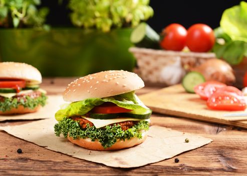 Homemade hamburgers with cheese, tomatoes and cucumbers