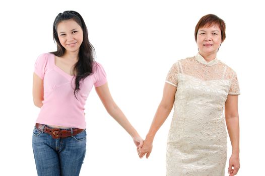 Adult daughter holding hands with mother isolated on white background. Mixed race Asian family portrait. 