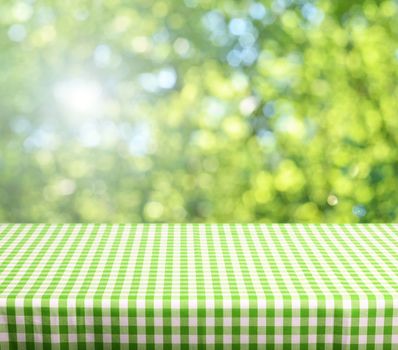 Empty table and defocused fresh green background