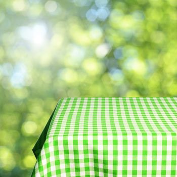 Empty table and defocused fresh green background