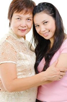Senior mother and adult daughter holding hands bonding isolated on white background. Mixed race Asian family portrait. 