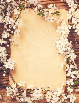 Spring blossom witth empty paper sheet on wood background - Vintage style