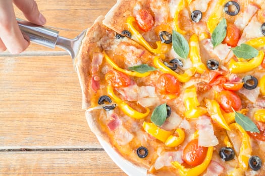 Serving piece of homemade pizza, stock photo