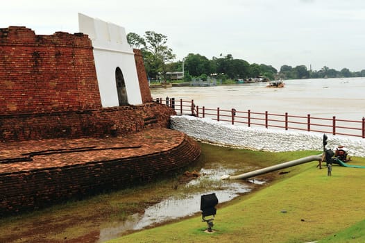 sandbags to protect ancient ruins in Ayuttaya, Thailand during the seasonal monsoon flooding.